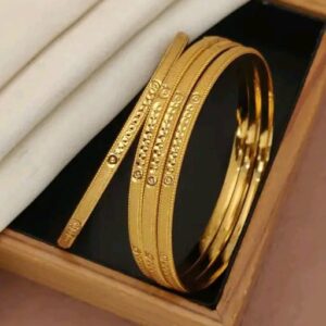 Stylish gold-toned bangles with a modern geometric pattern
