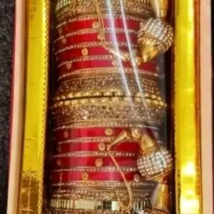 Includes a combination of sleek red bangles and intricately designed golden kadas. | Chudi