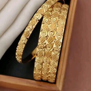 Stylish gold-toned bangles with a modern geometric pattern